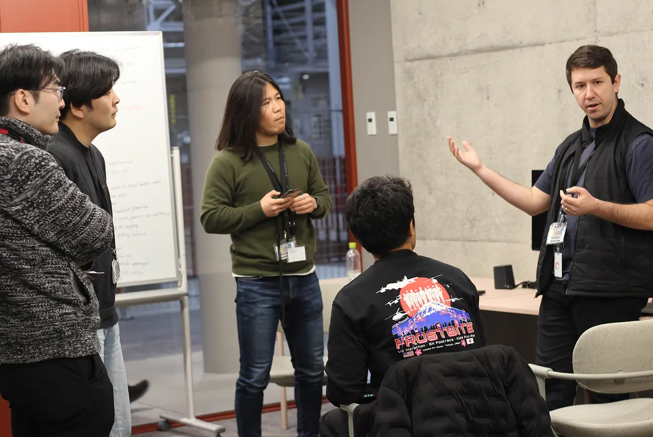Employees discussing ideas during hackathon with whiteboard