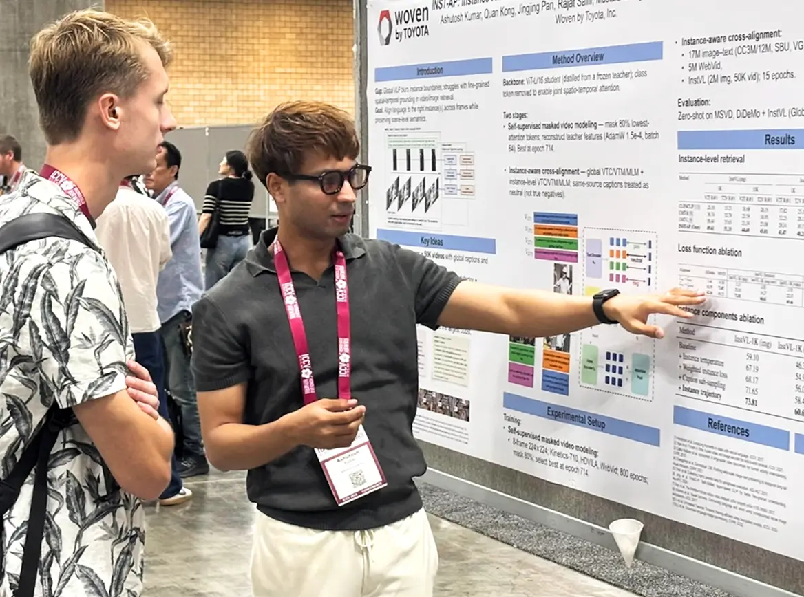 Engineer explaining research findings during technical poster session