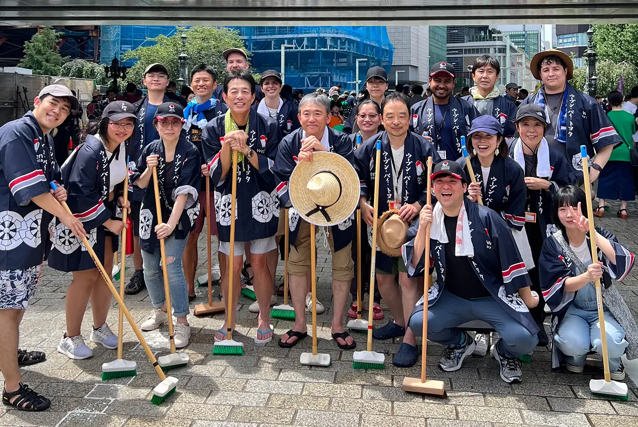 Employees participating in outdoor team activity with traditional festival attire