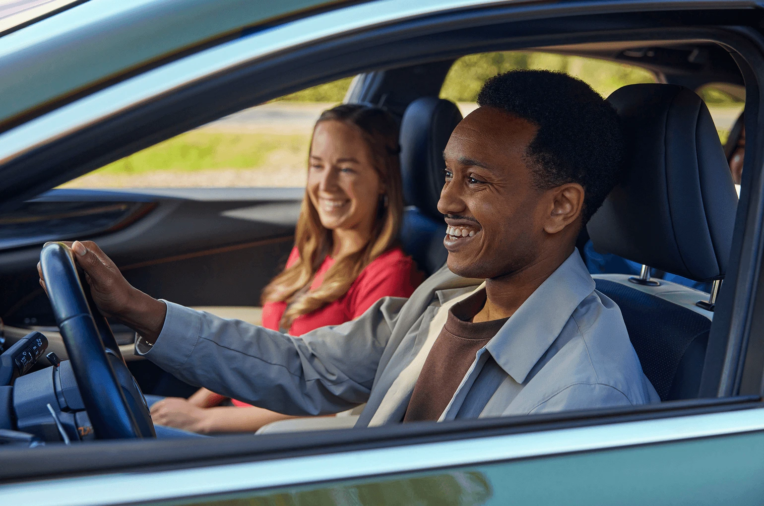 Driver and passenger enjoying connected mobility experience in vehicle