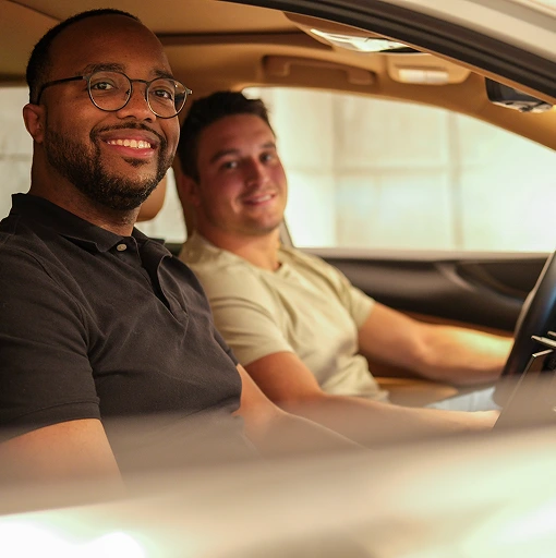 Driver and passenger in vehicle representing safe and reliable mobility experience